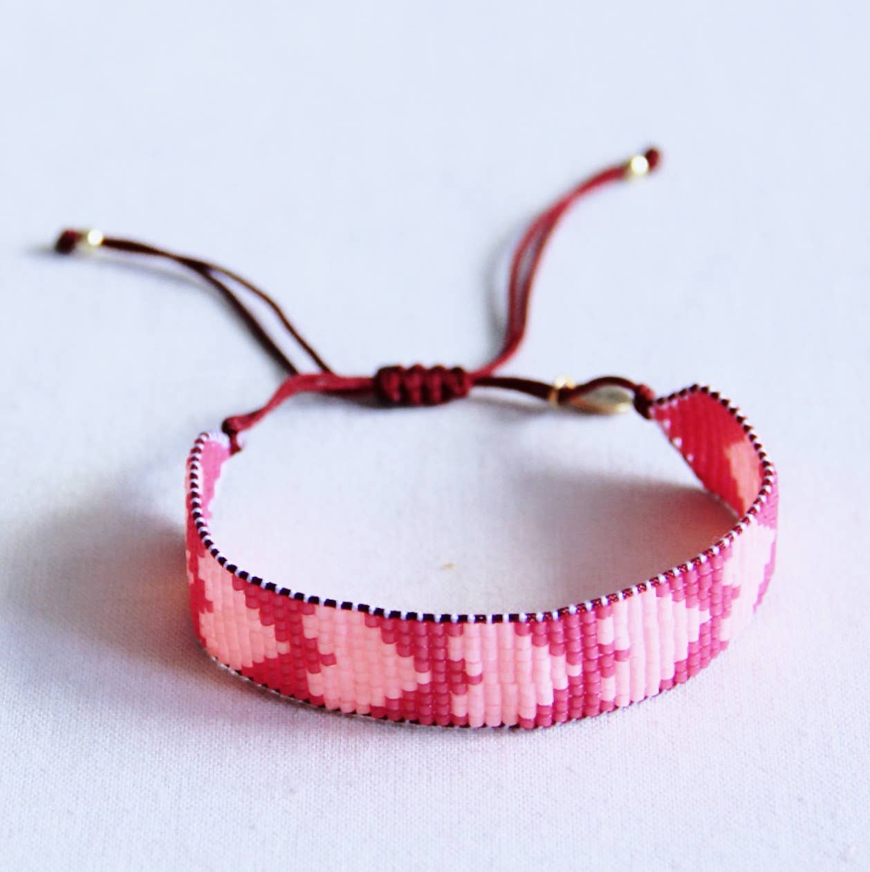 Bazou Braccialetto intrecciato con cuori - fucsia/pesca