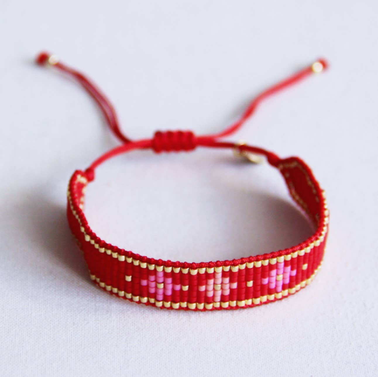Bazou Braccialetto intrecciato con motivo floreale - rosso/rosa