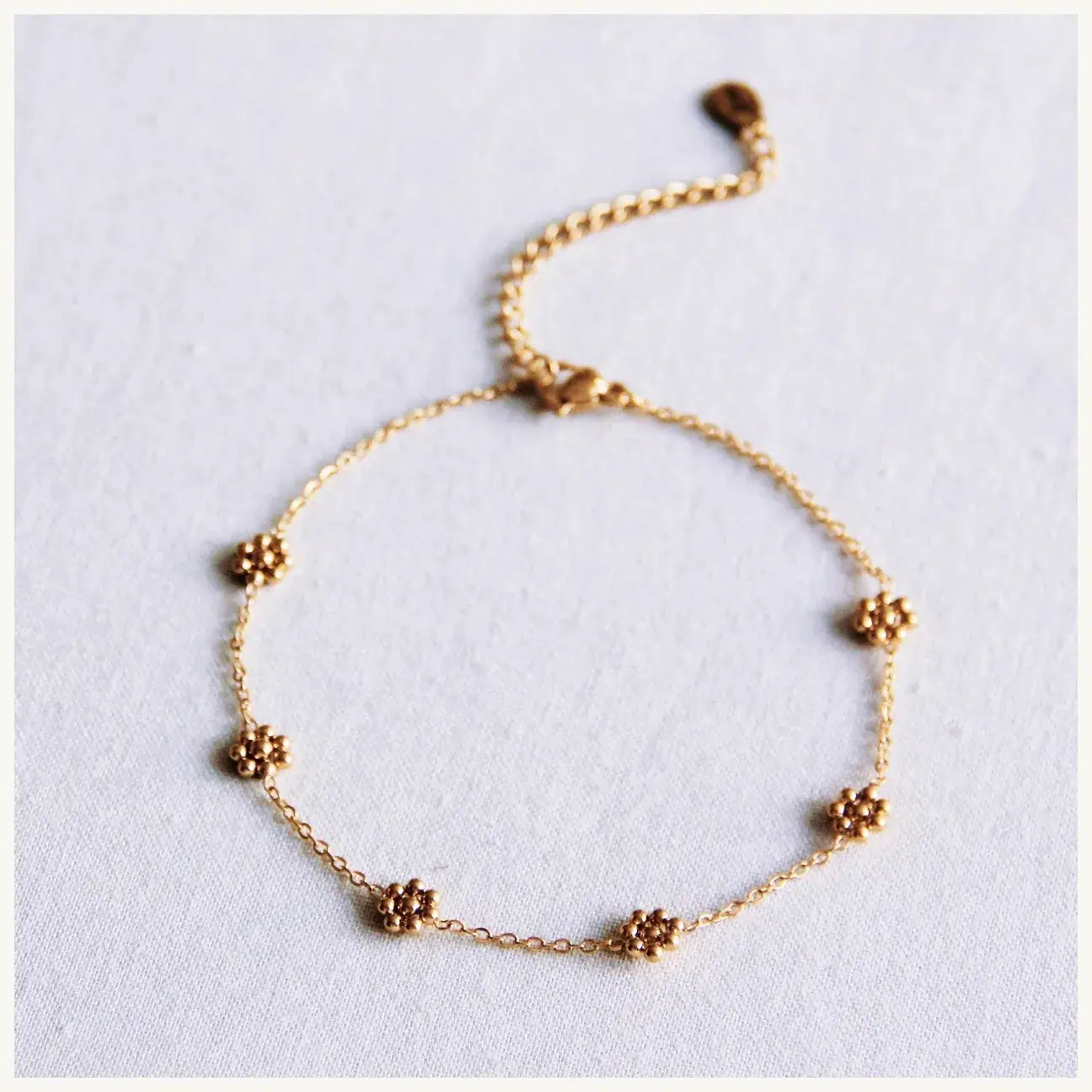 Bazou Cavigliera fine con margherite – oro